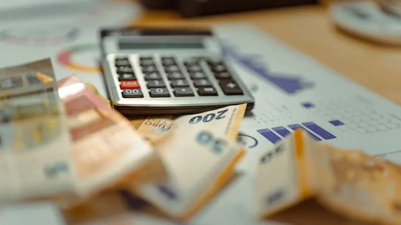 calculator and tax documents with euro banknotes financial planning