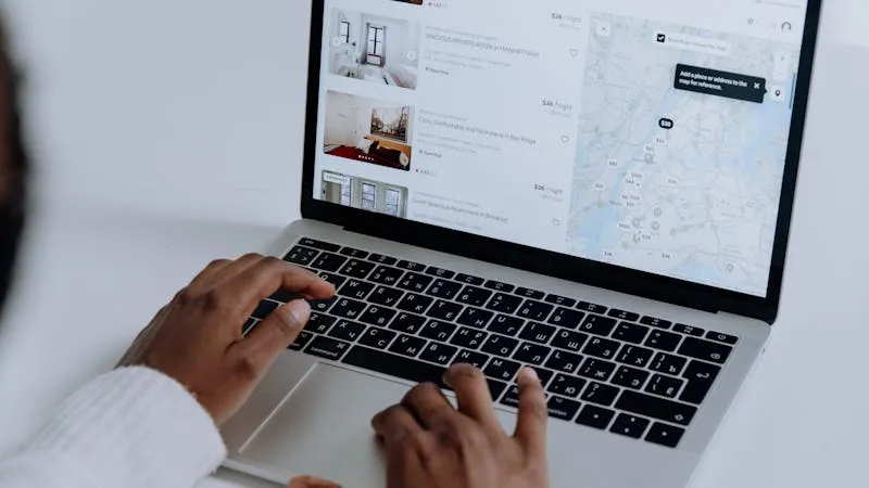 Real estate listing search on a laptop — comparing property portals